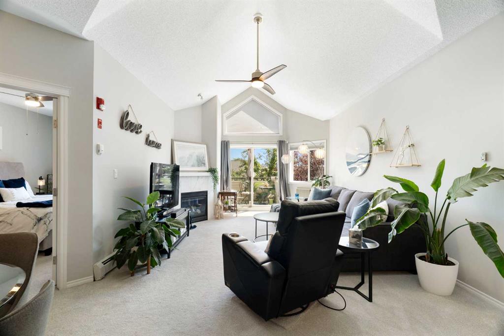 Living room with vaulted ceiling and fireplace